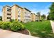 Exterior apartment grounds featuring large grassy areas and mature landscaping at 695 S Alton Way # 9C, Denver, CO 80247