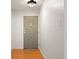 Hallway featuring wood floors and an exterior door at 695 S Alton Way # 9C, Denver, CO 80247