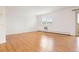Bright living room features a balcony, wood floors, and shuttered windows at 695 S Alton Way # 9C, Denver, CO 80247