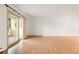 Bright living room features a balcony, wood floors, and shuttered windows at 695 S Alton Way # 9C, Denver, CO 80247