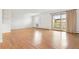 Bright living room features a balcony, wood floors, and shuttered windows at 695 S Alton Way # 9C, Denver, CO 80247