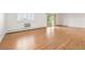 Bright living room features a balcony, wood floors, and shuttered windows at 695 S Alton Way # 9C, Denver, CO 80247