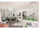 Bright living room with gray sofa, dining area, and hardwood floors at 2595 S Utica St, Denver, CO 80219