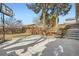 Large backyard featuring a concrete patio, basketball hoop, and tiered landscaping at 6233 W 75Th Ave, Arvada, CO 80003