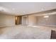 Open basement showcasing neutral tones and ample space for customization with partial view of stairwell at 6233 W 75Th Ave, Arvada, CO 80003
