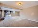 Spacious basement area featuring carpet, natural light, and sliding door access to the backyard at 6233 W 75Th Ave, Arvada, CO 80003