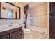 Functional bathroom with shower over tub combo, vanity sink and neutral tiling at 6233 W 75Th Ave, Arvada, CO 80003