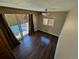 An empty bedroom with hardwood floors and a sliding glass door to patio at 6233 W 75Th Ave, Arvada, CO 80003