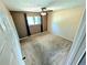 Bedroom featuring carpet, trim, window with curtains and a ceiling fan at 6233 W 75Th Ave, Arvada, CO 80003