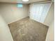 A basic bedroom with beige walls, carpet and a small window at 6233 W 75Th Ave, Arvada, CO 80003