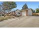 Well-maintained single-story home with an attached garage and a spacious driveway at 6233 W 75Th Ave, Arvada, CO 80003