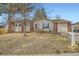 Charming single-story home featuring brick accents, a front deck, and an attached garage at 6233 W 75Th Ave, Arvada, CO 80003