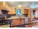 Functional kitchen with wooden cabinets, granite countertops, and stainless steel appliances at 6233 W 75Th Ave, Arvada, CO 80003