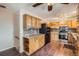A bright kitchen offers wood cabinets, black appliances, and modern tile backsplash at 6233 W 75Th Ave, Arvada, CO 80003