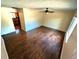 An empty living room featuring hardwood floors and a ceiling fan, ready for personalization at 6233 W 75Th Ave, Arvada, CO 80003