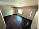 An empty living room featuring hardwood floors and a ceiling fan, ready for personalization at 6233 W 75Th Ave, Arvada, CO 80003