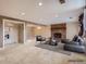 Spacious living room features a brick fireplace, neutral carpet, and recessed lighting at 6233 W 75Th Ave, Arvada, CO 80003