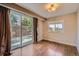 Bright living room featuring hardwood floors, sliding glass doors to the patio, and natural light at 6233 W 75Th Ave, Arvada, CO 80003