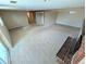 View of a large carpeted living room featuring a classic brick fireplace at 6233 W 75Th Ave, Arvada, CO 80003