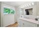 Bright bathroom featuring a white vanity, a large window, and wood plank flooring at 841 Beech St, Golden, CO 80401