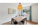 Light and airy dining area with decorative light fixture and backyard view at 841 Beech St, Golden, CO 80401