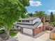 Home with a large, level yard, mature trees, and a brick and siding exterior at 841 Beech St, Golden, CO 80401