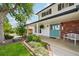Inviting front porch with double doors, white bench, and landscaped flower bed at 841 Beech St, Golden, CO 80401