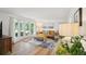 Bright living room with large windows, hardwood floors, and comfortable furnishings at 841 Beech St, Golden, CO 80401