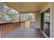 View of a covered wood deck with sliding glass door and backyard views at 6522 S Hoyt Way, Littleton, CO 80123