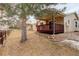 Exterior shot of home showing covered wood deck and yard space at 6522 S Hoyt Way, Littleton, CO 80123