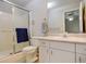 This bathroom features a vanity with plenty of storage and a shower with glass doors at 6522 S Hoyt Way, Littleton, CO 80123