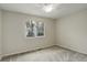 Bedroom with neutral paint, carpet, large window and ceiling fan at 6522 S Hoyt Way, Littleton, CO 80123