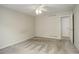 A carpeted bedroom with a ceiling fan and bright light entering through a window at 6522 S Hoyt Way, Littleton, CO 80123