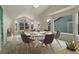 Dining area featuring vaulted ceilings, large windows, neutral tones and contemporary furnishings at 6522 S Hoyt Way, Littleton, CO 80123