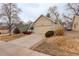 Charming single-story home with a two-car garage, a cozy front porch, and mature trees in a residential area at 6522 S Hoyt Way, Littleton, CO 80123