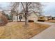 Street view of a charming single-story home with a two-car garage, a cozy front porch, and mature trees at 6522 S Hoyt Way, Littleton, CO 80123