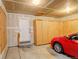 Garage with finished walls, and cabinetry, plus a new red car at 6522 S Hoyt Way, Littleton, CO 80123