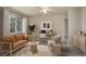 Cozy living room staged with modern furnishings and lots of natural light at 6522 S Hoyt Way, Littleton, CO 80123