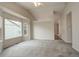 Bright living room with vaulted ceiling, neutral paint, large window, and plush gray carpeting at 6522 S Hoyt Way, Littleton, CO 80123