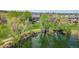 Aerial view of pond surrounded by lush trees and walking path at 10550 W Jewell Ave # 301, Lakewood, CO 80232
