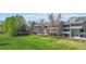 Lush, green lawn with trees surrounds townhomes at 10550 W Jewell Ave # 301, Lakewood, CO 80232