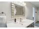 Bathroom vanity with a modern mirror and lighting fixtures, complemented by a sleek faucet and countertop at 10550 W Jewell Ave # 301, Lakewood, CO 80232