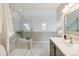 Sunlit bathroom featuring a glass shower with bench and skylights providing natural light at 10550 W Jewell Ave # 301, Lakewood, CO 80232