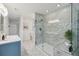 Bright bathroom featuring a glass enclosed shower with marble tiling and a stylish vanity with sleek fixtures at 10550 W Jewell Ave # 301, Lakewood, CO 80232