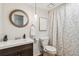 Well-lit bathroom with a modern sink, toilet, and decorative shower curtain at 10550 W Jewell Ave # 301, Lakewood, CO 80232