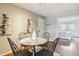 A cozy dining room with a round table, black chairs, and neutral decor at 10550 W Jewell Ave # 301, Lakewood, CO 80232