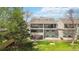 Multi-story home with multiple balconies and well-manicured backyard at 10550 W Jewell Ave # 301, Lakewood, CO 80232