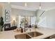 Modern kitchen showcasing a stainless steel sink, stone countertops, and an open view to living area at 10550 W Jewell Ave # 301, Lakewood, CO 80232