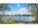 Relaxing lakeside view with a wooden bench to enjoy the scenic beauty at 10550 W Jewell Ave # 301, Lakewood, CO 80232