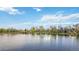 Calm lake view showing waterfront houses with lush green surroundings at 10550 W Jewell Ave # 301, Lakewood, CO 80232